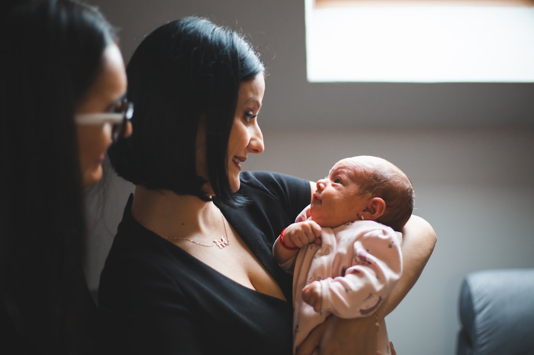 A doula supporting a mother and her newborn